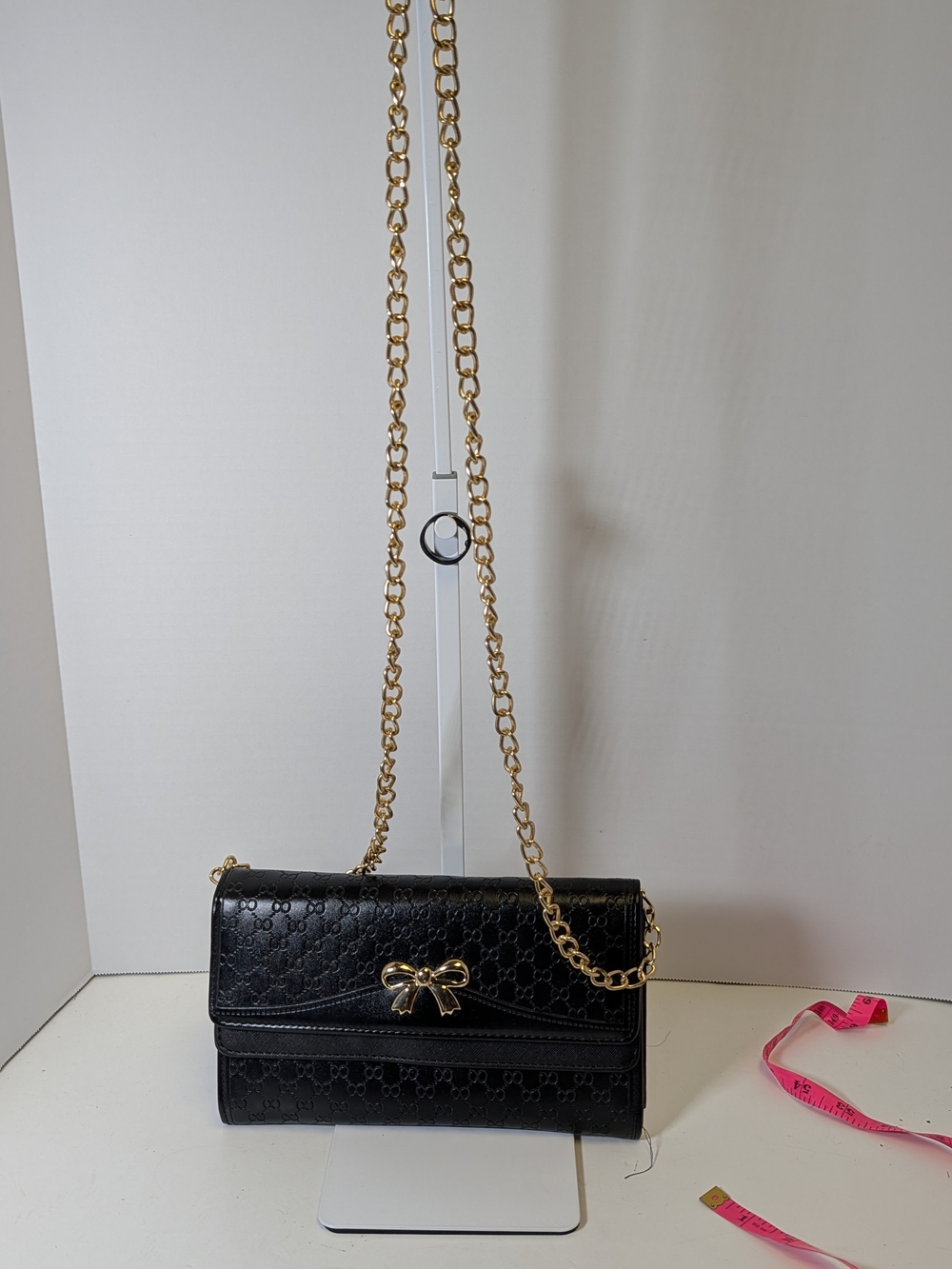 Black Quilted Crossbody Bag with Gold Bow Accent